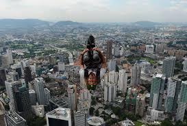 8Base jumper Malachi Templeton from New Zealand leaps from the top of the 421-meter Kuala Lumpur Tower during the International Tower Jump in Kuala Lumpur. - afp_malysia_base_jumping_27Sep12-975x659