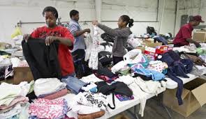 Volunteers, from left, Yvonne Gidden, Maximillion Gidden, Karen Arnold and Bernard Gidden, sort clothes donated at the Adventist Disaster Response warehouse ... - 9540593-large