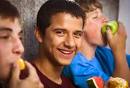 ... calories you would from a sweet drink from a wholesome food, like fruit. - getty_rf_photo_of_teen_boys_eating_fruit