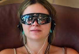 Aliana Abascal wears light therapy goggles and an Alpha-Stim cranial electrotherapy stimulator as she visits the Integrative Medicine symposium at the ... - Alternative+Medicine+Symposium+Held+University+kfadjfE19uql