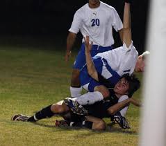 Central\u0026#39;s Michael Denmark, bottom, and Notre Dame\u0026#39;s Dustin Hutson, get tangled up after Denmark takes a shot on goal. [Order this photo] - 1284249-L