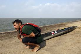 Exhausted, Andrew Condie, of Cuero, takes a breather while dragging his canoe the last quarter-mile after ... - 628x471