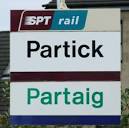 Dual language station sign. English and Gaelic sign at Partick railway - via Daymix