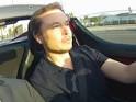 Elon Musk driving a Tesla