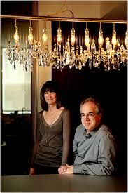 Desirée and Jeffrey Greene in the kitchen of their SoHo loft, under a Cellula chandelier designed by Nunzia Carbone and Tiziano Vudafieri. - 28004696