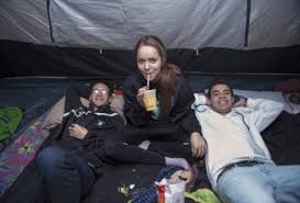 Coral Glades High School Students: Gustavo Lindo, Maria Bentancur and Camilo Rodriguez stay warm in their tent. Photo by Adam Baron - DSC_592920121121-350x237