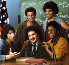 5 guys in front of a chalk board in class room