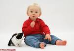 Toddler with black-and-white kitten and catnip mouse photo - WP23716