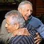 ... veteran Carrol Walsh, top, hugs Holocaust survivor Paul Arato Photo: AP