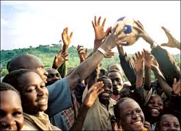 Photo 7 - Alex Zarifeh. Photo 7: Alex Zarifeh. Villagers celebrate the arrival of a donated football in rural Uganda before playing until nightfall. - _41798324_alex_zarifeh2_416x300