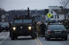 Firefighter shot at scene of fire; police hunt for gunman in ...
