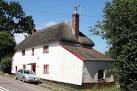 A cottage opposite Copplestone Mills. The blue plaque reads: 'Ernest Bevan - via Daymix