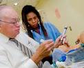 Dr. Curran suctions and opens