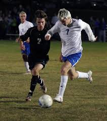 Notre Dame\u0026#39;s Taylor Essner dribbles the ball down field with heavy pressure from Central\u0026#39;s Michael Denmark. - 1284248-L