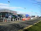 Automobile alley. Cheek by jowl new car showrooms in Mitchelston Industrial - via Daymix