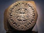 at a wooden Mayan calendar