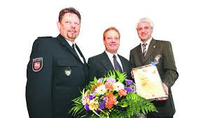 Für seine Zivilcourage ausgezeichnet: Walter Kreienborg (Mitte) erhält von Polizeioberrat Heinz Schevel (links) und Bürgermeister Dr. Kian Shahidi Blumen ...