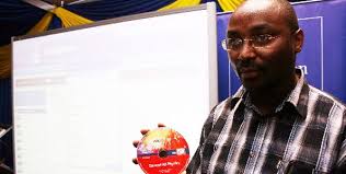 Education official Joseph Mbugua displays a CD that contains e-books at the Longman stand during the Nairobi International Book Fair last week. - mbugua