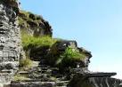 Each corner of the steps has a large flat stone set at waist-height, - via Daymix