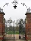 Ornate entrance gate. The wrought iron gate leads onto the grounds of - via Daymix
