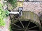 Water flows onto the backshot wheel. Mills Open Weekend 2011 - via Daymix