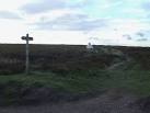White Cross known as Fat Betty and footpath sign in the evening light near - via Daymix