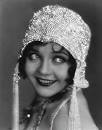 An actress in the 1920s. Dressed like a flapper. 