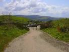 Path to the "Haslingden Halo". Scout Moor windfarm in the distance - via Daymix