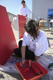 April Pedroza, 15, a student at Early College High School, paints a door at the SOY center alongside NLYM member Chase Braun, 14. - MG_2532-682x1024