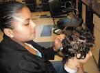 Senior cosmetology student Patricia Fuentes styles a wig as part of her ... - BK-Hair-026