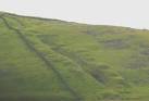 Manganese was mined, mainly in the 19thC, along a narrow seam stretching for - via Daymix