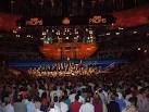 Visible behind the orchestra - via Daymix