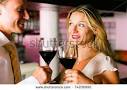 Man And Woman In A Hotel Bar In The Evening Having Glasses Of Red
