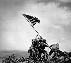 Americans raising their flag after capturing Iwo Jima from Japan (1945)