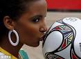 Tansey Coetzee kisses the official match ball for the FIFA 2009 ... - article-0-028AFB24000005DC-212_306x223