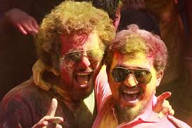 /MAHMUD HOSSAIN OPU/Al Jazeera. Two men daubed in colour shout as they enjoy the celebrations. - 2014317172458685645_8