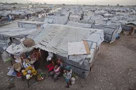 People without homes in the Jean-Marie Vincent camp for people displaced by the 2010 earthquake, wait for customers outside their tent where they have set ... - 2013-displacement-camp-for-2010-quake