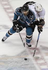 San Jose left wing Martin Havlat, left, and Anaheim right wing Bobby Ryan reach for the puck during the first period of an overtime contest on Thursday. - 0130sharksW-693x1024