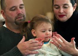 Doug Schmidt and Maria Salomão-Schmidt of Holliston with Olivia, whom they adopted from foster care. (John Tlumacki/Globe Staff). By Lisa Kocian - 539w