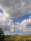 The small blob to the left of the mast is a maintenance pod on a cable - via Daymix
