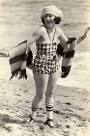 http://chuckman1920sarcadecardbeauties.files.wordpress.com/2011/09/photo-for-arcade-card-movie-star-vera-steadman-in-check-bathing-suit-big-bonnet-and-striped-scarf-on-beach.jpg