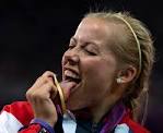 Great Britain's Hannah Cockroft licks her gold medal on the podium during ... - bp12