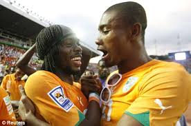 In hot water: Salomon Kalou celebrates World Cup qualification with Ivory Coast&#39;s Gervais Yao Kouassi (above left) and in action for Chelsea (below) - article-1228572-0738004A000005DC-642_468x311