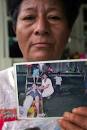 Dolores Morales holds a photo of her nineteen-year-old son Pedro who died of ... - crude_reflections_40