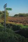 A couple of sturdy planks masquerade as a footbridge over a ditch on - via Daymix