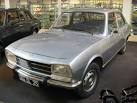 his 1977 Peugeot 504 at a