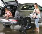 Jessica Alba puts her toned arms to use while escorting her two