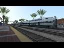 Metrolink train derails in crash with truck; emergency personnel.