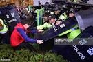 South Korean protestors clash with riot police during a rally to.