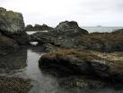 Very small sea arch. The little island on the horizon is West Mouse/Maen y - via Daymix